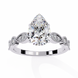 Diamond ring with a pear-shaped center stone on a white background