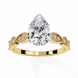 Gold ring with a large pear-shaped diamond and smaller diamonds on the band against a white background