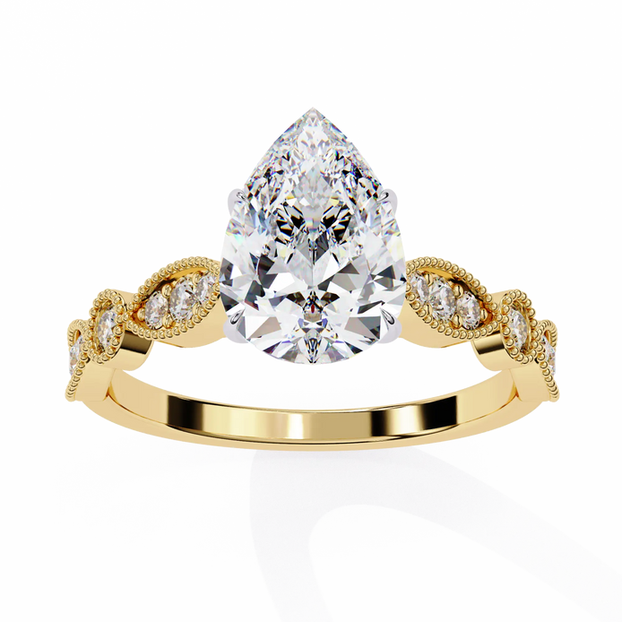 Gold ring with a large pear-shaped diamond and smaller diamonds on the band against a white background