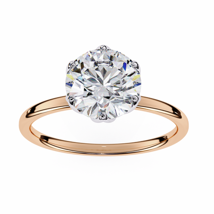 Rose gold ring with a large diamond on a white background