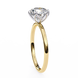 Gold ring with a clear gemstone on a white background