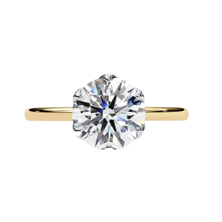 Gold ring with a large diamond on a white background