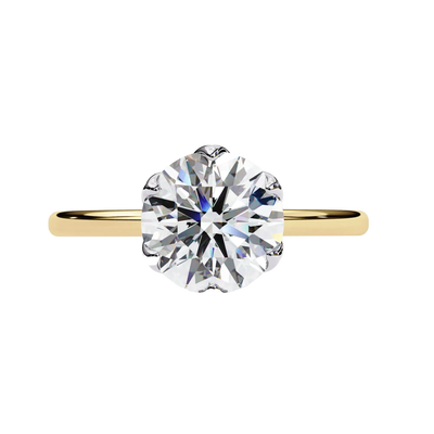 Gold ring with a large diamond on a white background