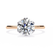 Diamond ring with rose gold band on a white background