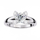 Silver ring with a large central diamond and smaller diamonds on the sides on a white background