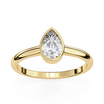 Gold ring with a pear-shaped diamond on a white background