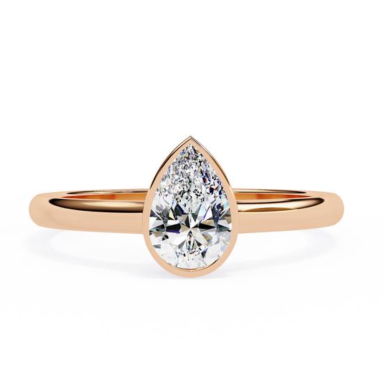Gold ring with a pear-shaped diamond on a white background