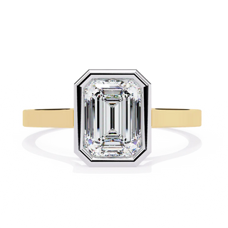 Diamond ring with yellow gold band on a white background