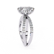 Diamond ring with a large central stone and smaller stones on the band against a white background