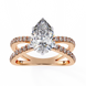 Rose gold ring with a pear-shaped diamond and smaller diamonds on a white background
