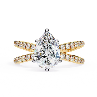 Gold ring with a pear-shaped diamond and smaller diamonds on a white background