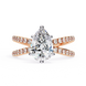 Rose gold ring with a pear-shaped diamond on a white background