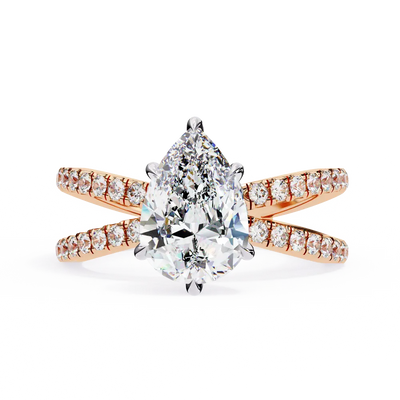 Rose gold ring with a pear-shaped diamond on a white background