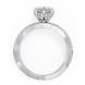 Diamond ring with a heart-shaped center stone on a white background