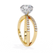 Gold ring with a large diamond and smaller diamonds on the band against a white background
