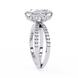 Diamond ring with a prominent center stone and smaller stones on the band against a white background