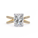 Gold ring with a large diamond and smaller diamonds on the band against a white background