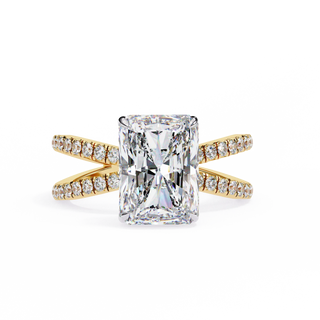 Gold ring with a large diamond and smaller diamonds on the band against a white background