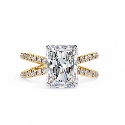 Gold ring with a large diamond and smaller diamonds on the band against a white background