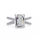Diamond ring with emerald-cut center stone on a white background
