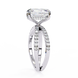 Diamond ring with a large central stone and smaller stones on the band against a white background