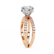 Rose gold ring with a large diamond and smaller diamonds on a white background