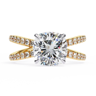 Gold ring with a large diamond and smaller diamonds on the band against a white background