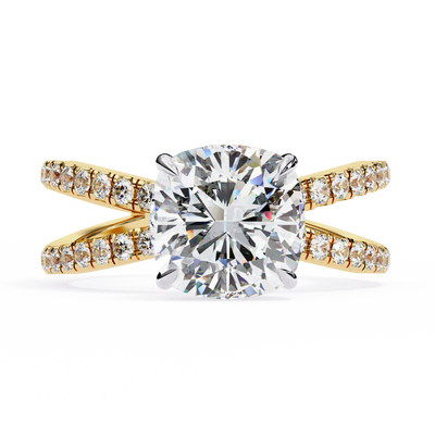 Gold ring with a large diamond and smaller diamonds on the band against a white background