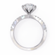 Diamond ring with a heart-shaped center stone on a white background