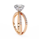 Rose gold ring with a large diamond and smaller diamonds on the band against a white background