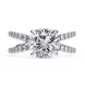 Diamond ring with a large central gemstone and smaller diamonds on the band against a white background