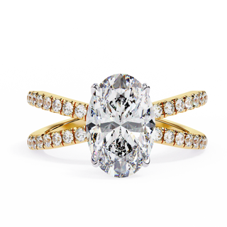 Gold ring with a large diamond and smaller diamonds on the band against a white background