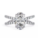 Diamond ring with a large central gemstone and smaller stones on the band against a white background