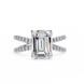 Diamond ring with emerald-cut center stone on a white background