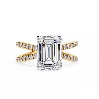 Diamond ring with emerald-cut center stone and gold band on a white background