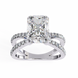 Diamond ring with a large central stone and smaller stones on the band against a white background