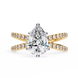 Gold ring with a pear-shaped diamond and smaller diamonds on a white background