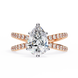 Rose gold ring with a pear-shaped diamond on a white background