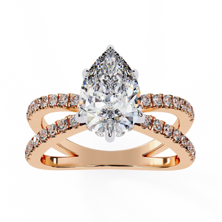 Rose gold ring with a pear-shaped diamond and smaller diamonds on a white background