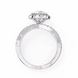 Silver ring with a large diamond and smaller diamonds on the band against a white background