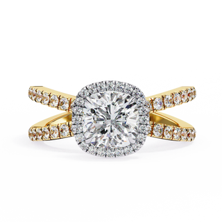 Gold ring with a large diamond and smaller diamonds on the band against a white background