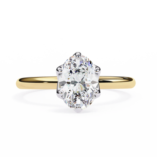 Gold ring with a large diamond on a white background