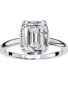 Diamond ring with a emerald-cut diamond on a white background