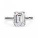 Diamond ring with emerald-cut diamond on a white background