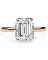 Rose gold ring with a large emerald-cut diamond on a white background