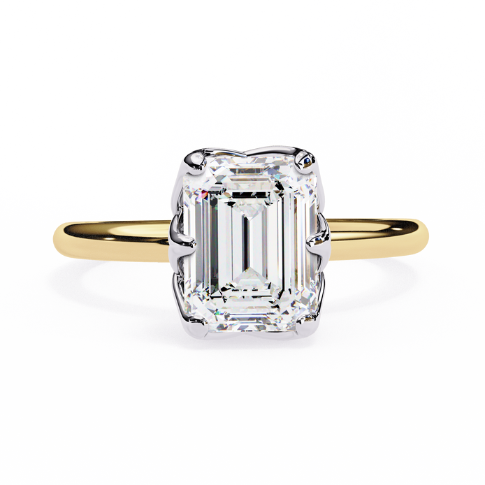 Gold ring with a large emerald-cut diamond on a white background