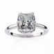 Diamond ring with a rectangular cut gemstone on a white background