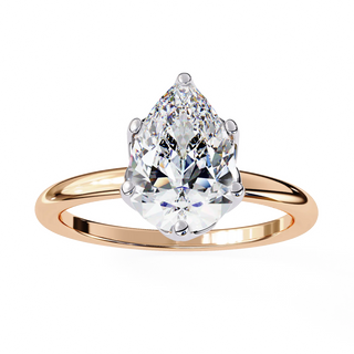 Rose gold ring with a pear-shaped diamond on a white background