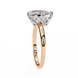 Rose gold ring with a diamond on a white background