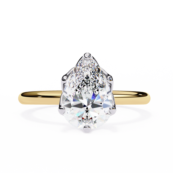 Gold ring with a pear-shaped diamond on a white background